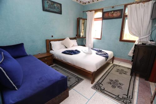 a bedroom with a bed and a couch in it at Equi Palace & SPA Near Aeroport in Berrechid