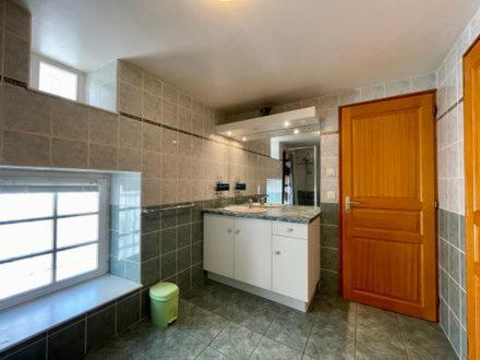 a large kitchen with a red door in a room at gite La Fermette in Valprivas