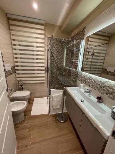 a bathroom with a toilet and a sink and a shower at Dimora Lucia in Troia