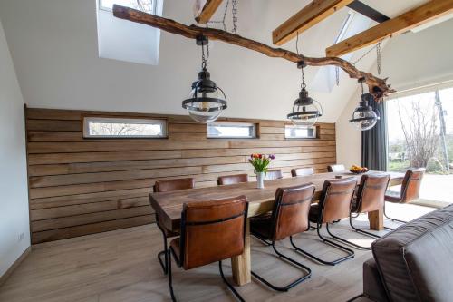 a dining room with a long table and chairs at erve Middendorp in Ansen