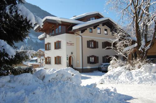 a building with a pile of snow in front of it at Gästehaus Brugger in Neukirchen am Großvenediger