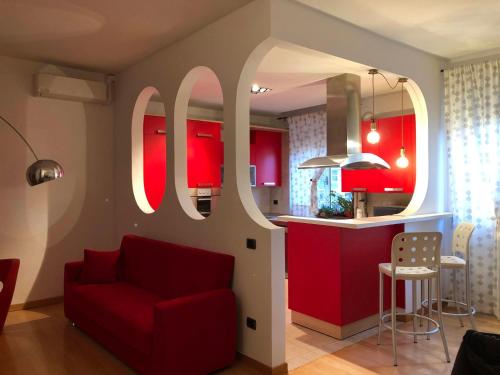 a living room with red cabinets and a red couch at Appartamento A casa di Tamy in Fabriano