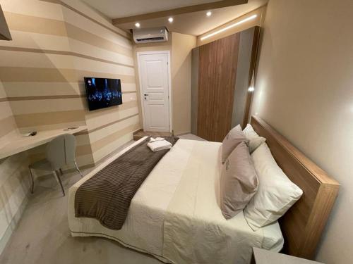 a small bedroom with a bed and a desk at Dimora Lucia in Troia