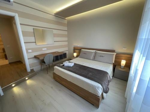 a bedroom with a large bed and a desk at Dimora Lucia in Troia