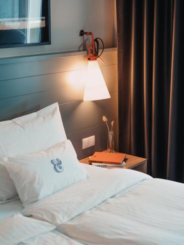 a bedroom with a bed and a lamp on a table at Saint SHERMIN bed breakfast & champagne in Vienna