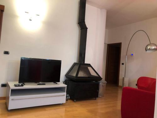 a living room with a stove and a tv at Appartamento A casa di Tamy in Fabriano