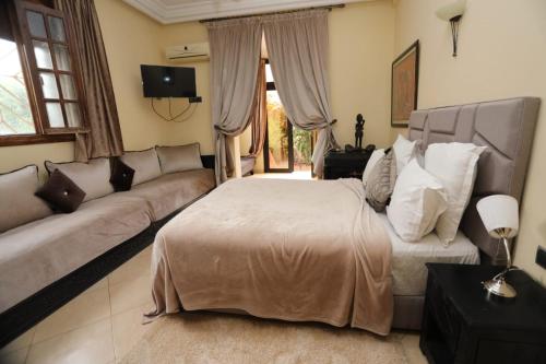 a living room with a bed and a couch at Equi Palace & SPA Near Aeroport in Berrechid