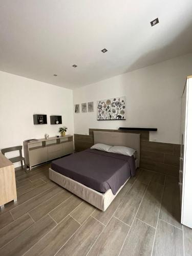 a bedroom with a bed and a table in it at Casa vacanze San Francesco in Barletta