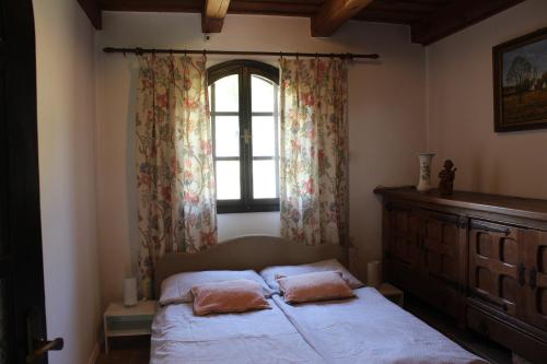 A bed or beds in a room at Napsugár Vendégház