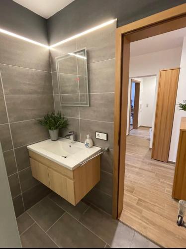 a bathroom with a sink and a mirror at Ferienwohnung Wolf in Seebruck