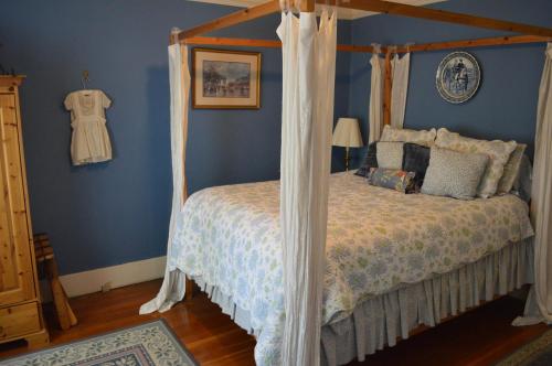a bedroom with a bed with a canopy at GlenMorey Country House in Placerville
