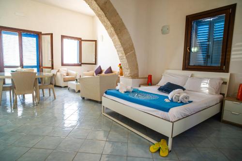 a bedroom with a bed and a living room at Mare E Timo in Marettimo