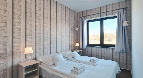 Posteľ alebo postele v izbe v ubytovaní Apartamenty Sasinówka