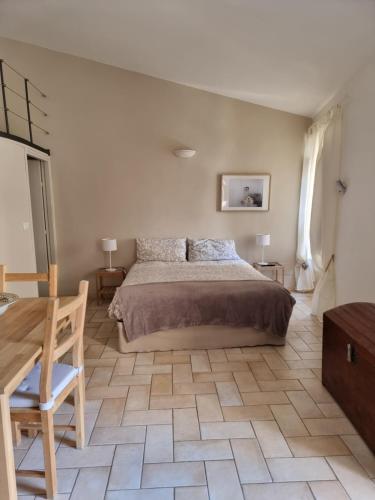 a bedroom with a large bed and a wooden table at Alloggio Turistico Gasparrini in Bevagna