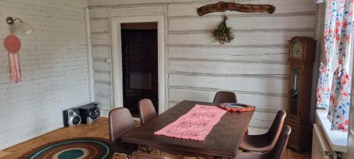 a dining room with a table and chairs at Filipówka in Sztabin