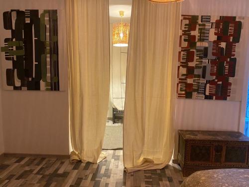 a bedroom with a bed and a window with curtains at Bel Appart Cosy plein coeur de Tanger vue mer in Tangier