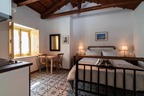 a bedroom with a bed and a table in a room at Rafalias Mansion in Hydra