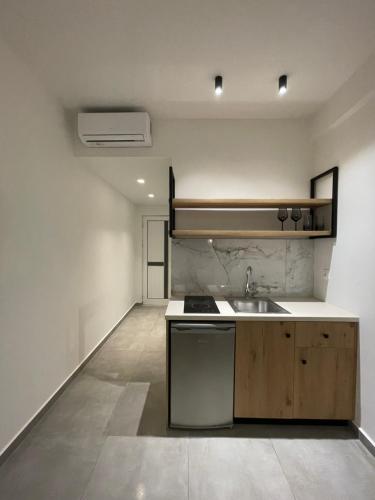 an empty kitchen with a sink and a stove at George Deluxe Apartments in Stalís