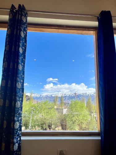 a window with a view of a mountain at Niri-la Guest house Leh in Leh
