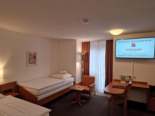 a hotel room with a bed and a television at Hotel Gerberhof in Backnang