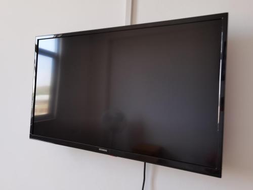 a flat screen television hanging on a wall at Casa Talara in Talara