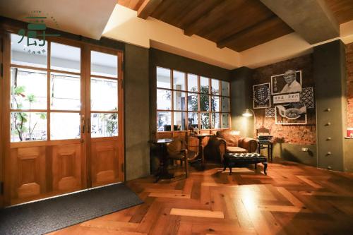 a room with a door and a chair and a table at Roots Chew Hotel in Tainan