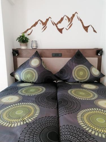 a bed with two pillows on top of it at Hölbinger Alm - Apartments in Anger