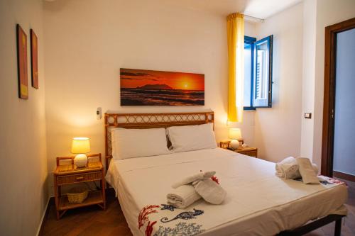 a bedroom with a bed with a stuffed animal on it at La terrazza del sole “ apartments “ in Marettimo