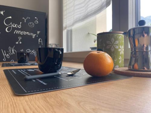 an orange sitting on top of a table with a black cutting board at Meraki Dolomiti in Longarone