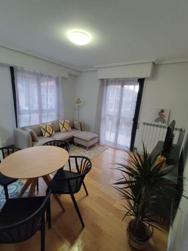 a living room with a table and a couch at Sagasti in Astigarraga