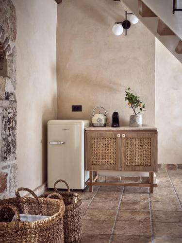 a kitchen with a refrigerator and baskets at Leeda's Village in Lithakia