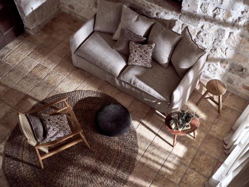 an overhead view of a living room with a couch and chairs at Leeda's Village in Lithakia