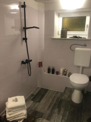a white bathroom with a toilet and a window at HannaHs in Salzhausen