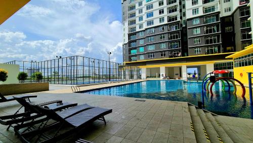 a swimming pool with a playground in the middle of a building at J&J Vacation Home@Novo8 Residence in Kampong Tambak