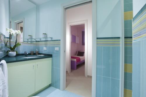 a bathroom with a sink and a mirror at Estate4home - L'onda viola in Sorrento