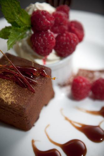 a piece of chocolate dessert with raspberries on a plate at Inverness Palace Hotel & Spa, WorldHotels Distinctive in Inverness