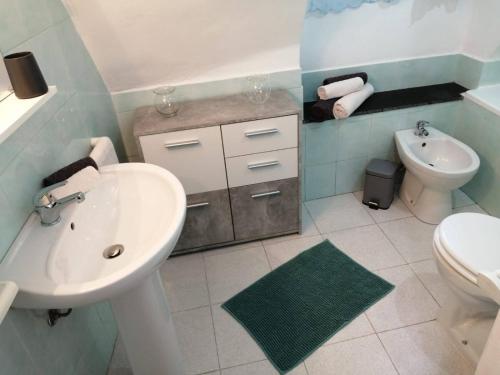 a white bathroom with a sink and a toilet at Casa di nonno Memé CITRA 008035-LT-0018 in Andagna