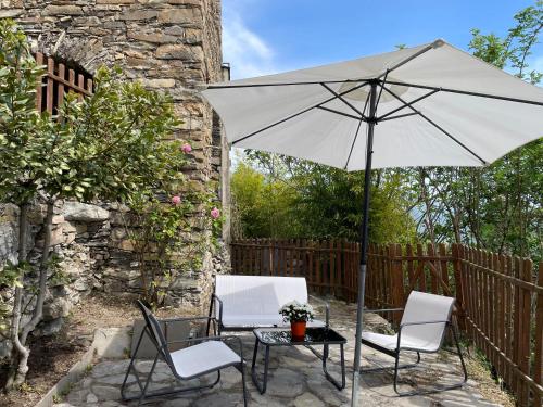 a table and two chairs and an umbrella on a patio at Casa di nonno Memé CITRA 008035-LT-0018 in Andagna