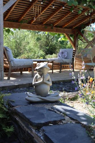 a statue sitting on the ground in a yard at La Petite Boire - Chambres d'hôtes près d'Angers in Mûrs-Érigné