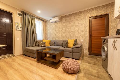 a living room with a couch and a table at Garden House in Tbilisi City