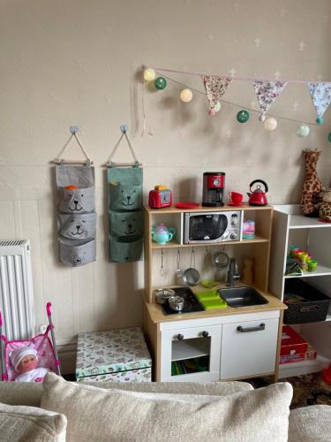 a childs toy kitchen with a toy stove in a room at Beaucliffe continental in Blackpool