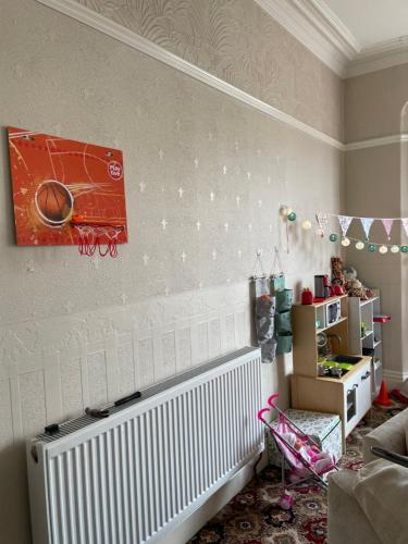 a living room with a radiator and a picture on the wall at Beaucliffe continental in Blackpool