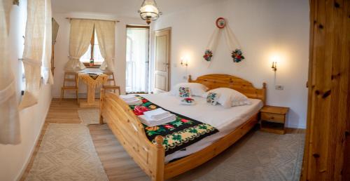 a bedroom with a large wooden bed in a room at Poiana Brazilor in Borşa