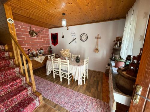 a kitchen and dining room with a table and chairs at Guesthouse "Gjin Thana" in Theth