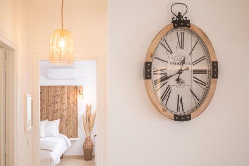 a clock hanging on a wall in a room at Alta Vista 2 Luxury House in Kardamaina