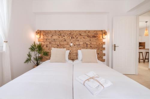 a bedroom with a white bed with two white pillows at Alta Vista 2 Luxury House in Kardamaina
