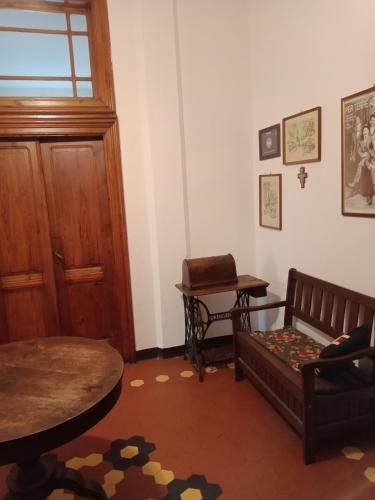 a living room with a wooden door and a couch at Casa con Vista - Border House - Pontremoli in Pontremoli
