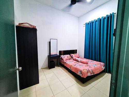 A bed or beds in a room at Q&R Homestay Residence
