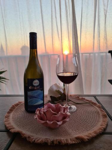 a bottle of wine and a glass on a table at Kaya house in Nerežišća