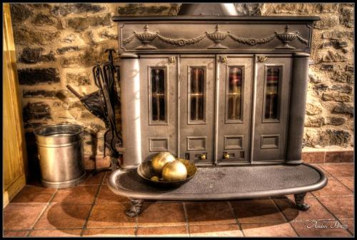 a bowl of fruit on a table in front of a cabinet at La Borda de Mery. in Charo